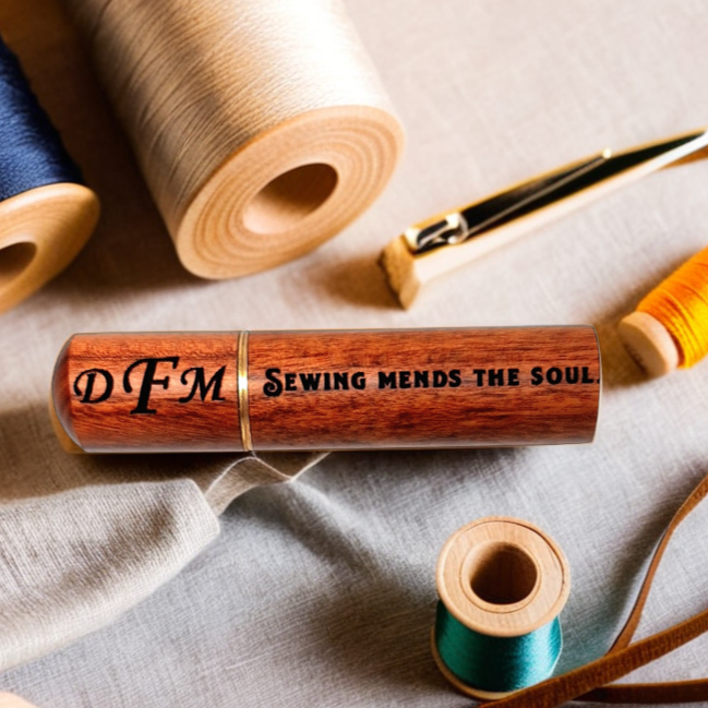 Engraved wooden needle case with sewing supplies background
